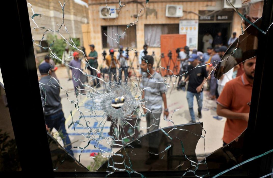 Members of media are seen through a broken glass window inside the premises of the district Malir jail after dozens of prisoners escaped from the jail on the outskirts of Karachi, Pakistan, June 3, 2025. REUTERS/Akhtar Soomro/File Photo