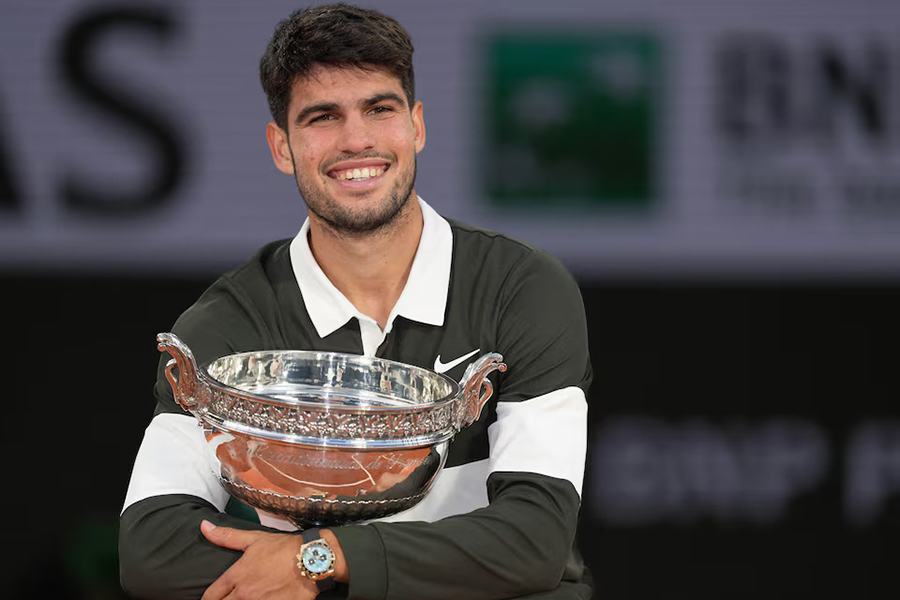 Carlos Alcaraz of Spain poses with the trophy after winning the men’s singles final against Jannik Sinner of Italy on Day 15 of the 2025 French Open at Roland Garros Stadium in Paris, France, on June 8, 2025 — USA TODAY Sports via Reuters
