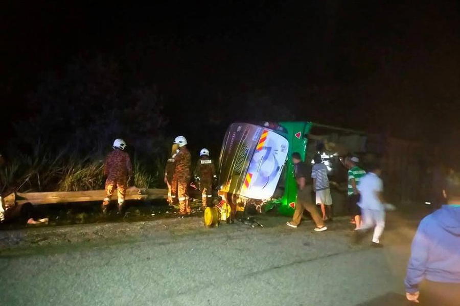 A four-man team from Gerik Fire and Rescue Station, who arrived at the site nearly an hour later, found the bus overturned following the tragic accident— INFO.SEMASA/FACEBOOK via The Straits Times