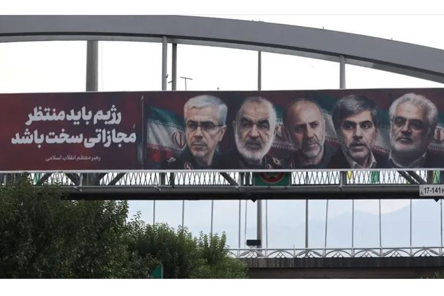 Pictures of those killed in Israeli strikes on Iran are displayed on a street, in Tehran, Iran, June 15, 2025. (Reuters)