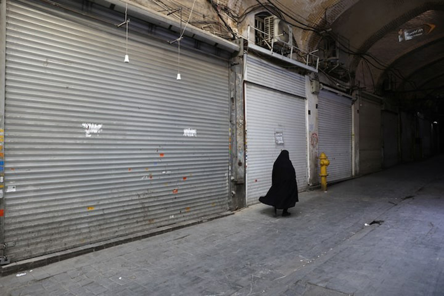 A person walks in front of closed shops in the Tehran Bazaar following the Israeli strikes on Iran, in the centre of Tehran, Iran on June 16, 2025 — WANA (West Asia News Agency) via REUTERS