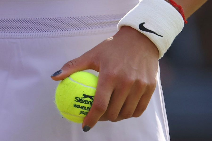 Tennis - Queen's Club Championships - Queen's Club, London, Britain - June 12, 2025 General view of Wimbledon branded tennis ball on the hand of China's Qinwen Zheng during her round of 16 match against McCartney Kessler of the US.
