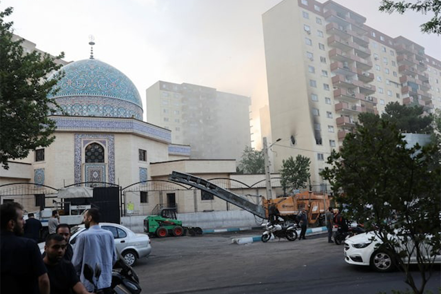 Smoke rises as a building stands damaged in the aftermath of Israeli strikes, in Tehran, Iran on June 13, 2025 — WANA (West Asia News Agency) via REUTERS