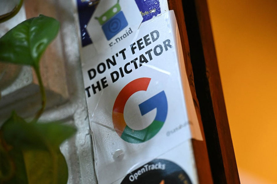 A sticker with a "Don't feed the dictator" message is pictured at the Topio organization's market stall, which supports the transition to alternative operating systems for smartphones, tablets, and laptops, independent of major tech companies like Google or Apple, in Berlin, Germany April 23, 2025.