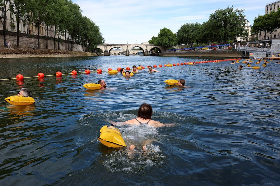 People swim in the River Seine at the Bras Marie site, opened to swimmers marking the first public bathing session in the capital's historic waterway, in Paris, France, July 5, 2025.