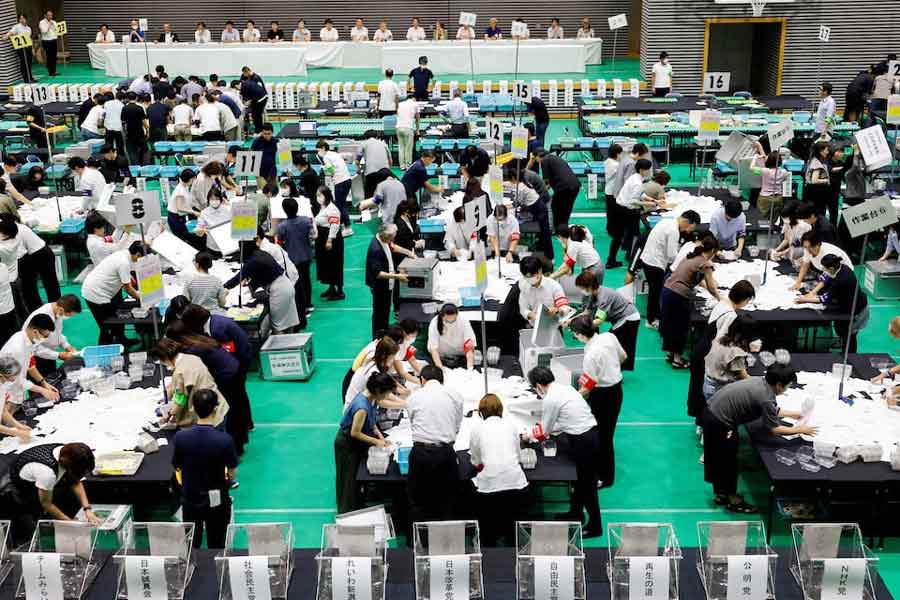 Election officials count votes at a ballot counting centre for Japan's upper house election in Tokyo, Japan, July 20, 2025.