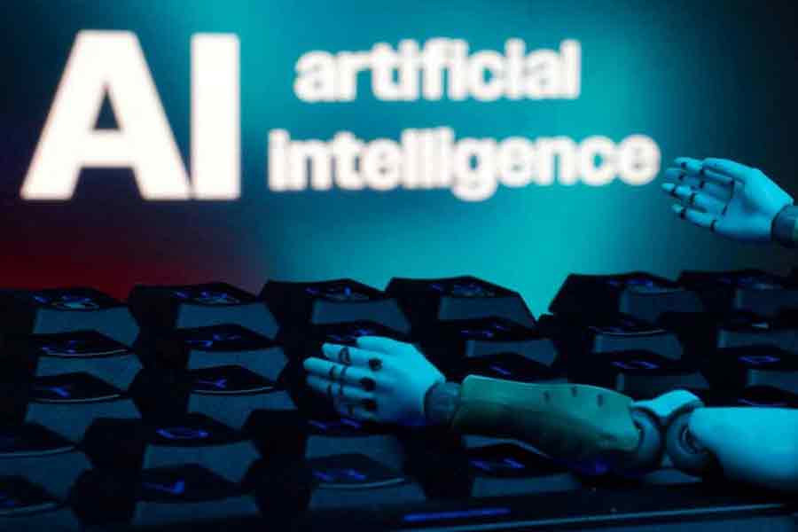 A message reading "AI artificial intelligence", a keyboard, and robot hands are seen in this illustration taken Jan 27, 2025.