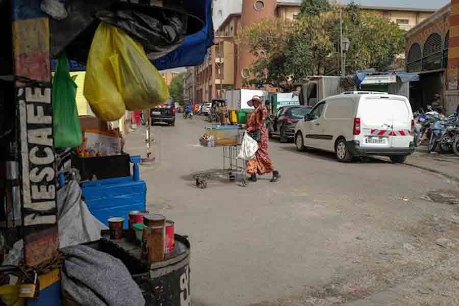 A street food vendor pushes her cart near Kermel Market in downtown Dakar, Senegal, May 21, 2025.