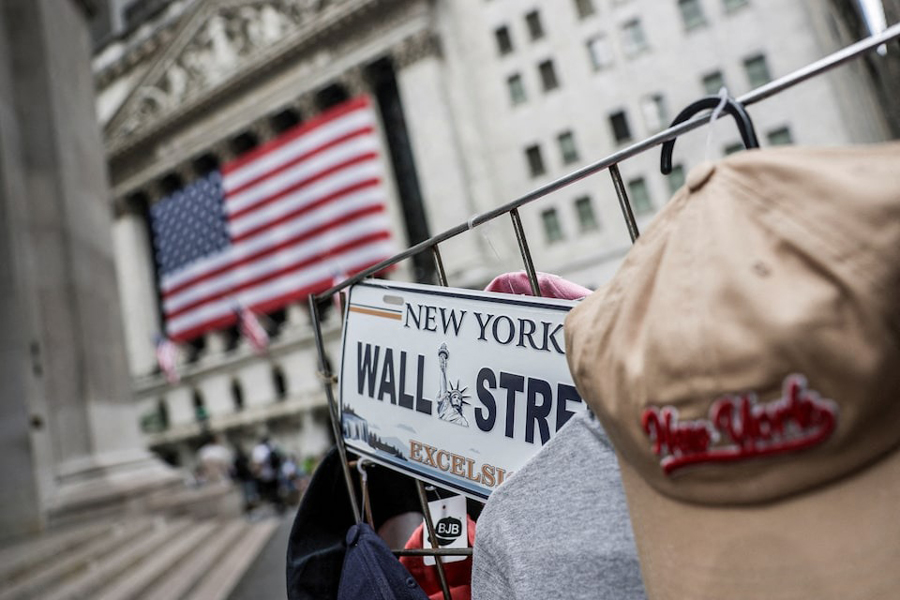 A Wall Street plate is seen on a street vendor stall outside the New York Stock Exchange (NYSE) in New York City, US, July 11, 2025.