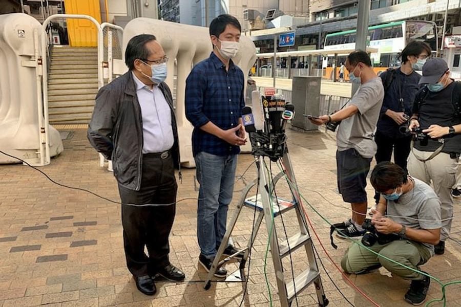 Former lawmaker Ted Hui Chi-fung speaks to members of the media after he was released on bail, next to Albert Ho, outside Western Police Station in Hong Kong, China November 18, 2020.