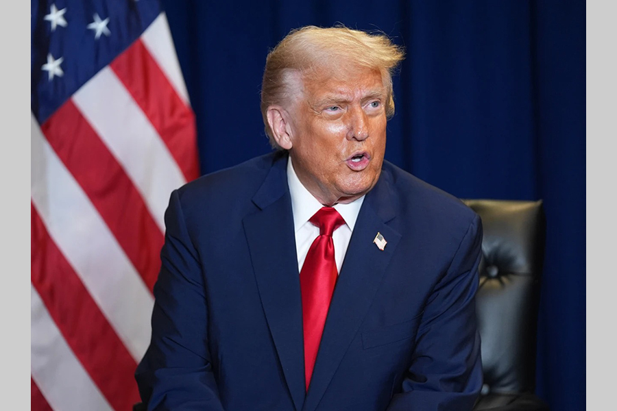 In front of drowning nations, Trump calls climate change a 'con job'