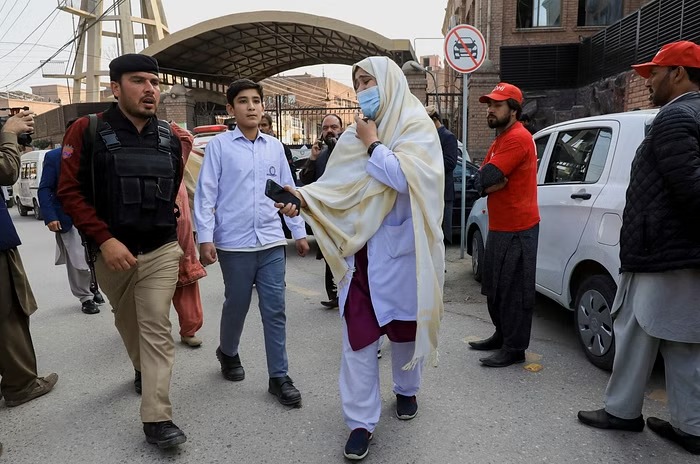 A woman reacts as she searches for her relatives, after a suicide blast in a mosque in Peshawar, Pakistan, Jan 30, 2023.