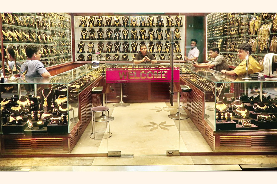Jewellers sit idle as the number of buyers remains very low following a sharp rise in gold prices in recent weeks. The photo was taken at the Baitul Mukarram gold market on Wednesday. — FE Photo by Shafiqul Alam