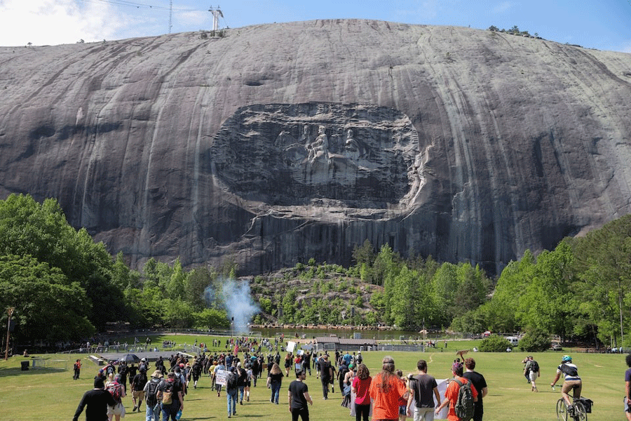 A group of counter-protesters walk towards a group celebrating Confederate Memorial Day at Stone Mountain Park in Stone Mountain, Georgia, US, April 30, 2022.