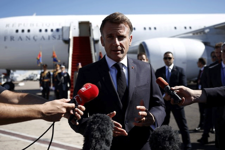 French President Emmanuel Macron speaks to the members of the media, after arriving by plane to attend the Gaza Peace Summit, in Sharm el-Sheikh, Egypt, October 13, 2025.