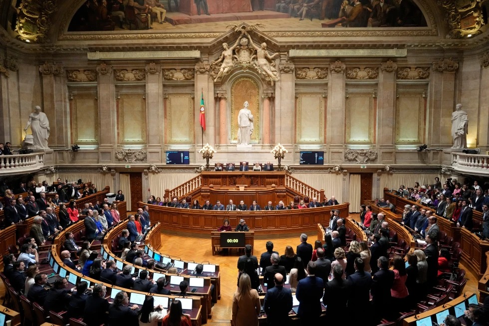 Members of opposition parties stand to vote against a government confidence motion at the Portuguese parliament in Lisbon, Tuesday, March 11, 2025. (AP Photo/Armando Franca, file)