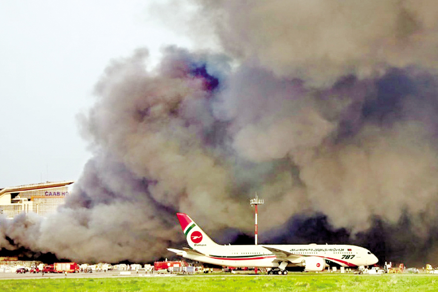 Thick plumes of smoke billow out as a huge fire rips through the cargo section of Hazrat Shahjalal International Airport in Dhaka on Saturday, forcing the suspension of all flights which later resumed. — FE Photo