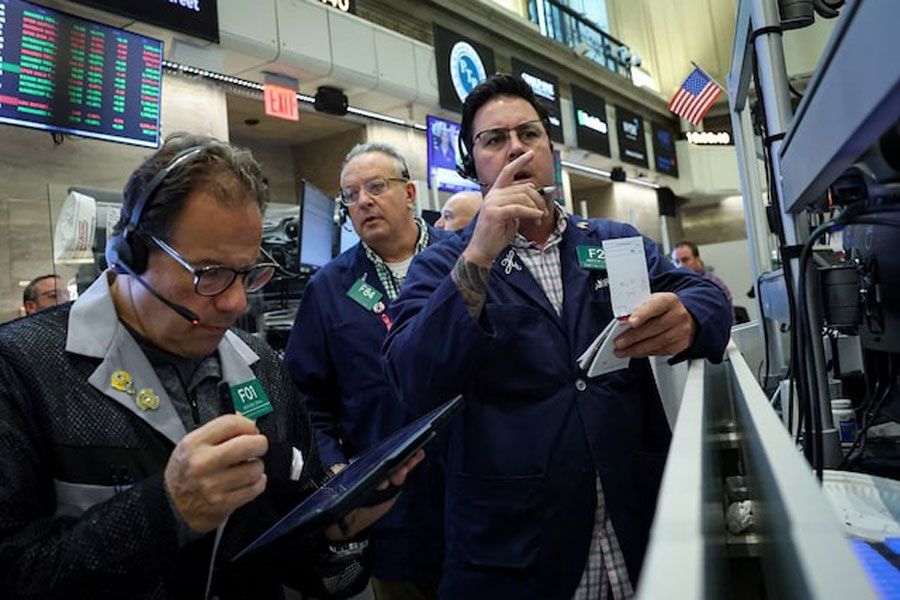 Futures-options traders work on the floor at the New York Stock Exchange's NYSE American in New York City, U.S., October 22, 2025.