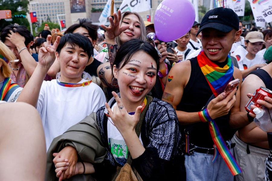People pose as they participate in the annual Taiwan Pride parade in Taipei, Taiwan, October 25, 2025.