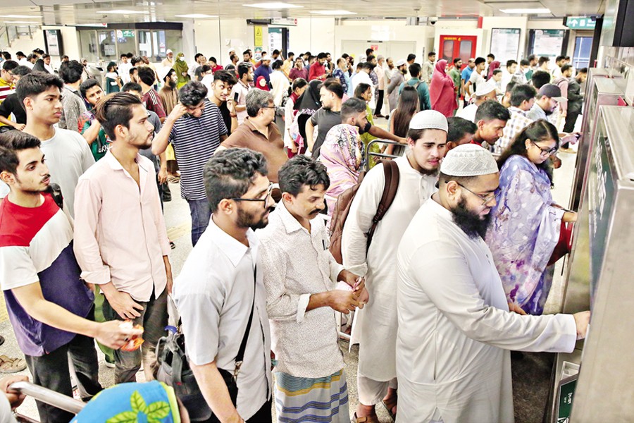 Commuters in large number crowd the Motijheel metro-rail station in Dhaka on Thursday, opting for the better service, due to the lack of alternative road transport options. — FE photo