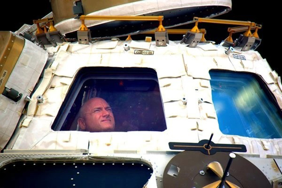In this undated photo provided by NASA on Tuesday, March 1, 2016, astronaut Scott Kelly looks out the cupola of the International Space Station — NASA via AP, File