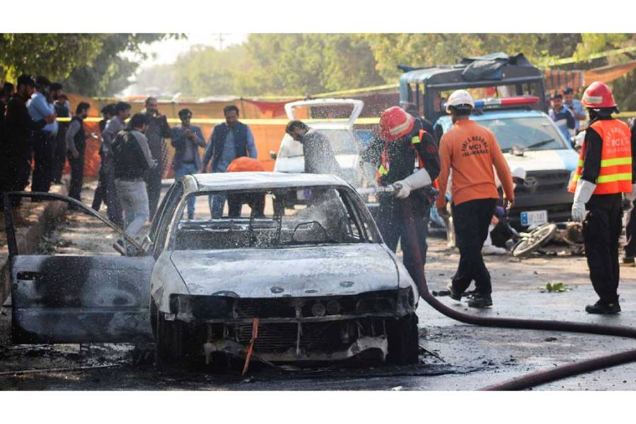 Firefighter douses a vehicle after a blast outside a court building in Islamabad, Pakistan Nov 11, 2025.