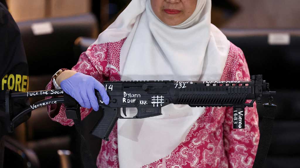 FILE PHOTO: Head of Indonesian Child Protection Commission (KPAI) Margaret Aliyatul Maimunah holds a 'toy firearm', with text written using wite-out, as evidence is displayed during a press conference following explosions that occurred at a mosque inside a school complex during Friday prayers last week, at Jakarta police headquarters in Jakarta, Indonesia, Nov 11, 2025. REUTERS/Willy Kurniawan/File Photo
