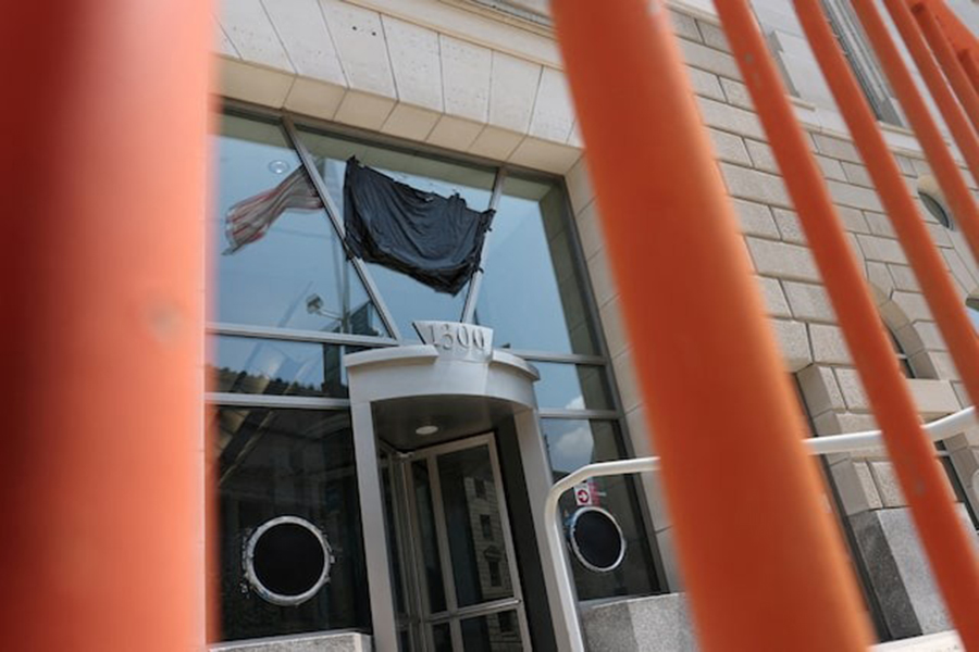 A US flag is reflected in the windows of the shuttered former offices of the US Agency for International Development (USAID) in Washington, DC, US on July 22, 2025 — Reuters/File
