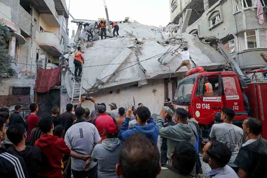 Palestinians inspect the site of an Israeli strike, in Gaza City, Nov 22, 2025.
