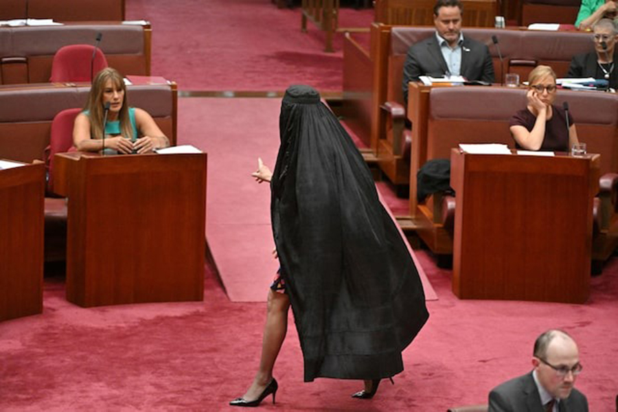 One Nation leader Pauline Hanson wears a burqa in the Senate chamber at Parliament House in Canberra, Australia on November 24, 2025 — AAP via REUTERS