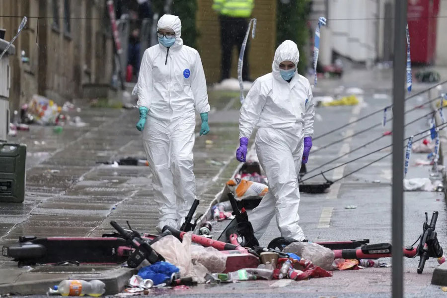 Forensic officers examine the site where a 53-year-old British man plowed a minivan into a crowd of Liverpool soccer fans who were celebrating the city’s Premier League championship Monday, injuring more than 45 people in Liverpool, England, Tuesday, May 27, 2025.
