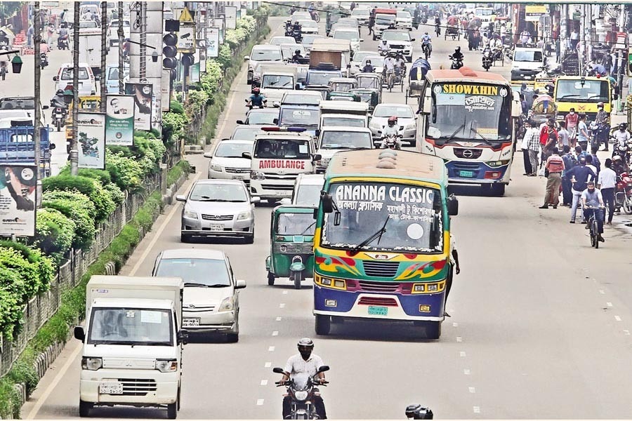Long-distance buses running alongside private cars on the Airport Road at Banani in the city on Sunday, as the government allowed them to operate for a limited period amid the lockdown to facilitate the transportation of garment workers returning to Dhaka.