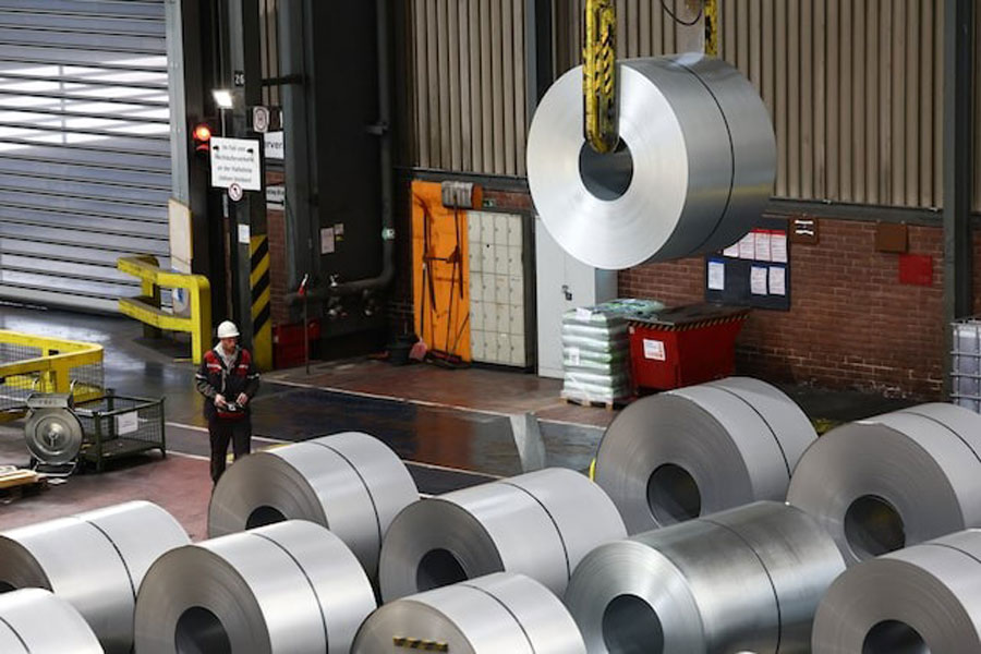 A worker moves a steel coil with a crane at a ThyssenKrupp steel factory in Duisburg, Germany, November 5, 2025.