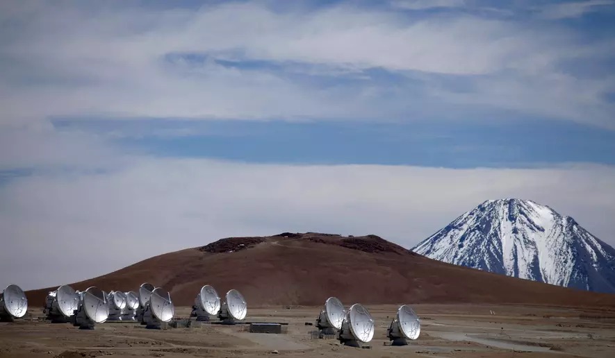 FILE - Radio antennas are spread out on the terrain as part of one of the world's largest astronomy projects, the Atacama Large Millimeter/submillimeter Array (ALMA) in Chajnator in the Atacama desert in northern Chile, Sept. 27, 2012. (AP Photo/Jorge Saenz, File)