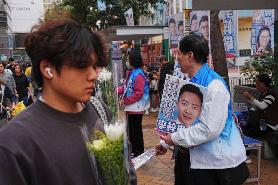 Supporters of New People’s Party candidate Dominic Lee distribute campaign leaflets in Tai Po during the Legislative Council general election, in Hong Kong, China, December 7, 2025.
