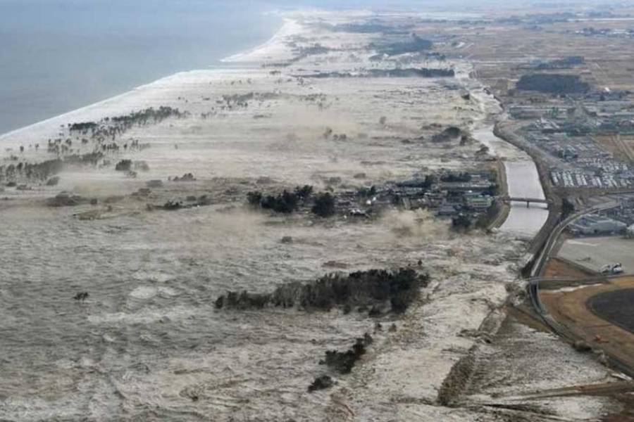 A massive tsunami hits the coastal areas of Iwanuma, Miyagi Prefecture, northeastern Japan, March 11, 2011.