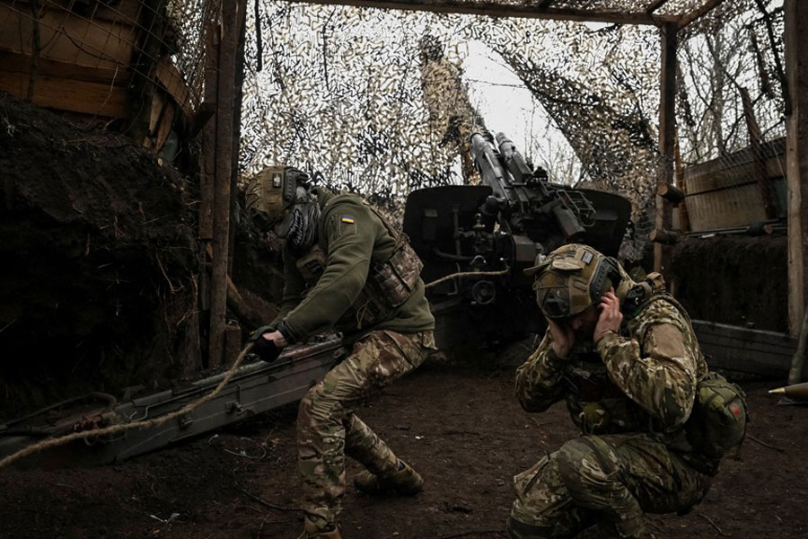 Artillerymen of the 152nd Separate Jaeger Brigade fire a howitzer towards Russian troops, amid Russia's attack on Ukraine, near the frontline town of Pokrovsk in Donetsk region, Ukraine Dec 11, 2025.