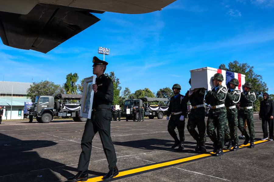 Military personnel carry the coffin of Private Mustageem Chema, covered by the Thai national flag, during a procession ceremony to transport bodies to their home town, at a military airport amid deadly clashes between Thailand and Cambodia along a disputed border area, in Ubon Ratchathani province, Thailand, December 14, 2025.