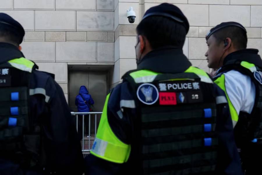 People queue outside the West Kowloon Magistrates' Courts building for the verdict in the national security collusion trial of Jimmy Lai, founder of the now-defunct pro-democracy newspaper Apple Daily, in Hong Kong, China, December 15, 2025.