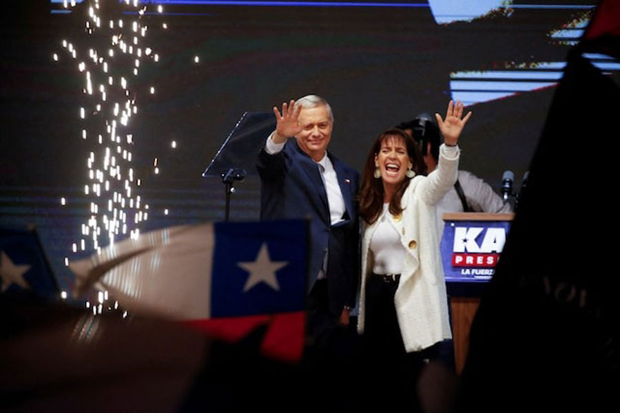 Jose Antonio Kast, presidential candidate of the far-right Republican Party of Chile and his wife Maria Pia Adriasola, wave as they celebrate after Kast won Chile's presidency in a presidential runoff election, in Santiago, Chile, December 14, 2025.