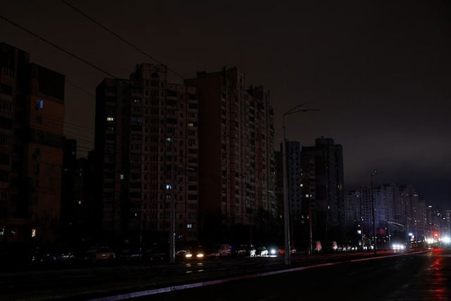 Cars move along a dark street during a power blackout after critical civil infrastructure was hit by recent Russian missile and drone strikes, amid Russia's attack on Ukraine, in Kyiv, Ukraine December 27, 2025.