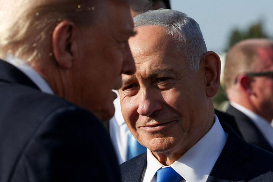 Israeli Prime Minister Benjamin Netanyahu looks at U.S. President Donald Trump.