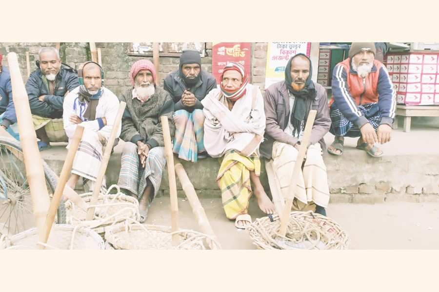Day labourers sit idle due to lack of work because of inclement weather. The photo was taken at Shapla Chattar in Rangpur city-FE Photo