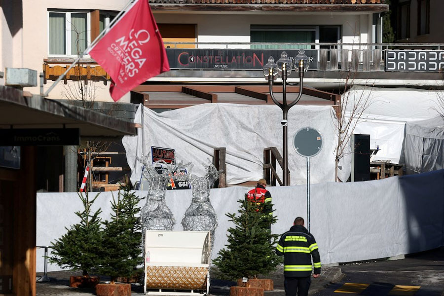 Emergency personnel work at the site of an explosion and fire at the "Le Constellation" bar, where several people died and others were injured after an explosion tore through a crowded New Year’s Eve party, according to Swiss police, in the upscale ski resort of Crans-Montana in southwestern Switzerland, January 1, 2026.