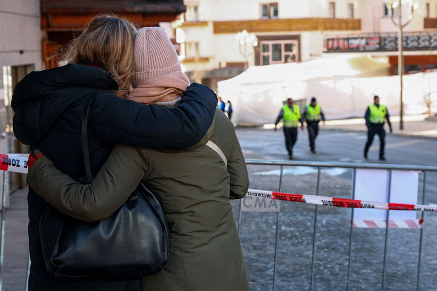 People hug near the site of an explosion and fire at the "Le Constellation" bar, where several people died and others were injured after an explosion tore through a crowded New Year’s Eve party, according to Swiss police, in the upscale ski resort of Crans-Montana in southwestern Switzerland, Jan 1, 2026.