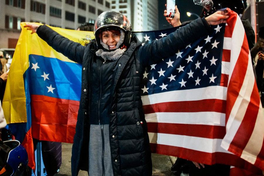 A person reacts holding Venezuelan and US flags as Venezuelan immigrants celebrate after the United States struck Venezuela and captured its President Nicolas Maduro and his wife Cilia Flores, and they were brought to the Metropolitan Detention Center in Brooklyn (MDC Brooklyn), in New York City, US, Jan 3, 2026.