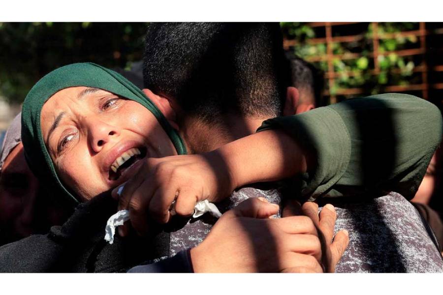 Mourners hug each other during the funeral of Palestinians who, according to medics, were killed in an Israeli strike on Sunday, at Nasser Hospital in Khan Younis, southern Gaza Strip, Jan 11, 2026.