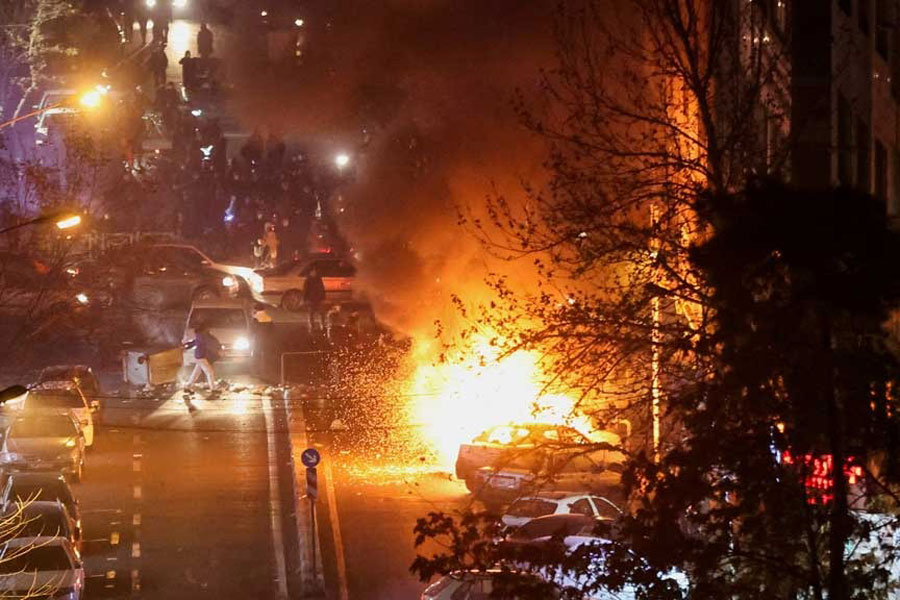 Cars burn in a street during a protest over the collapse of the currency's value, in Tehran, Iran, Jan 8, 2026.
