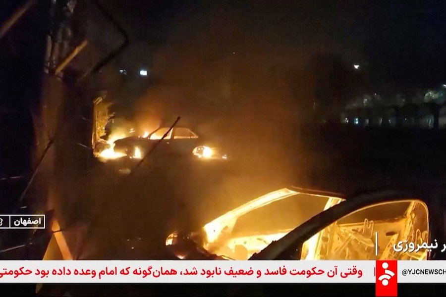 Flames engulf cars following unrest sparked by dire economic conditions, in a place given as Isfahan, Iran, January 9, 2026, in this screengrab from Iran's state media broadcast footage.