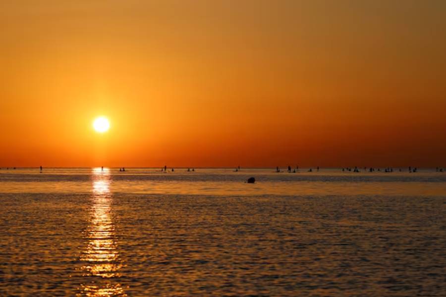 Tourists and locals paddleboard at the sunrise on the Mediterranean Sea in Barcelona, Spain July 2, 2025.